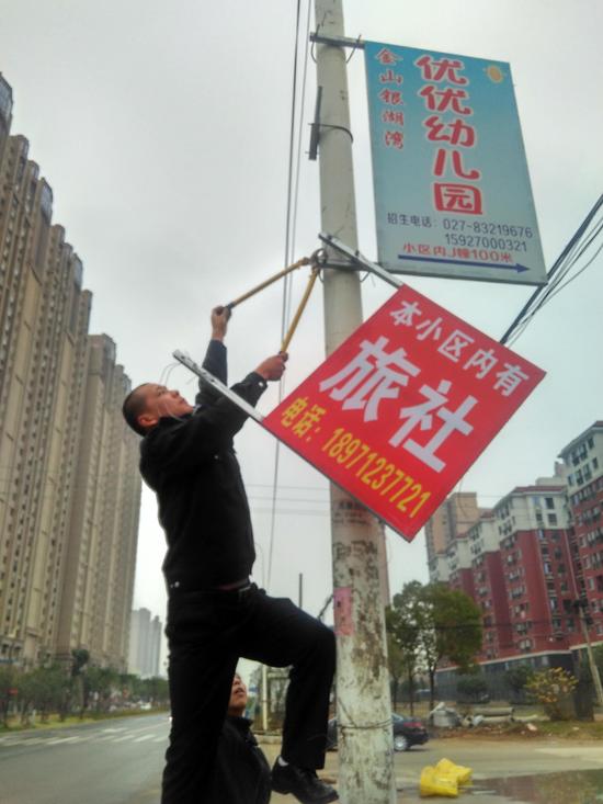 徑河城管拆下違規(guī)廣告牌